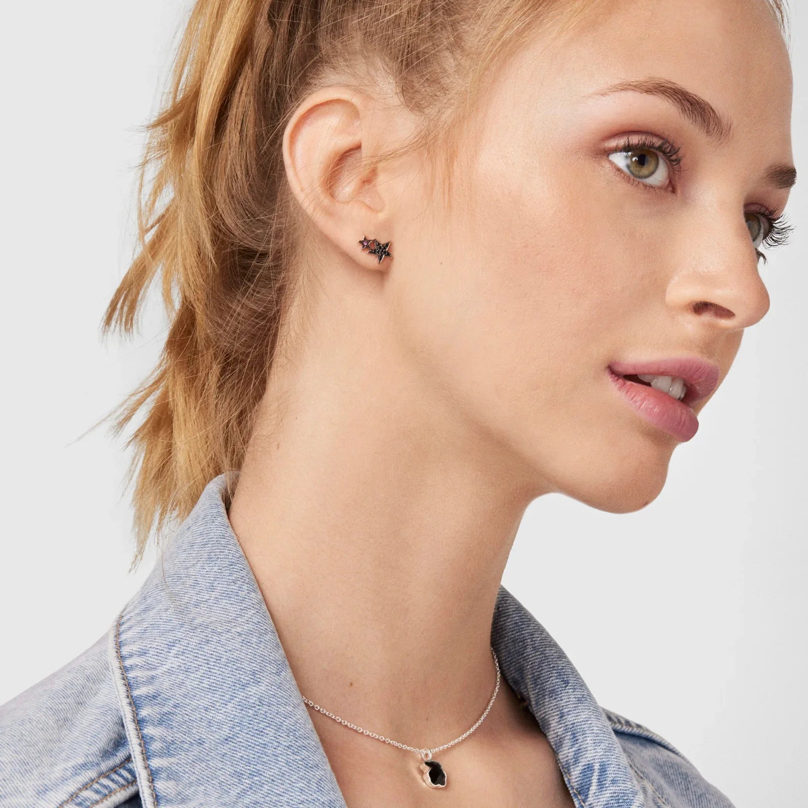 דוגמנית עונדת עגיל ותליון אופנתי, עם ג'קט ג'ינס, מבית CHOZEN קבוצת אלפא