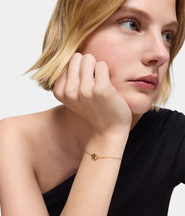 דוגמנית עם שיער קצר עונדת צמיד זהב עדין, צילום קמפיין תכשיטים CHOZEN