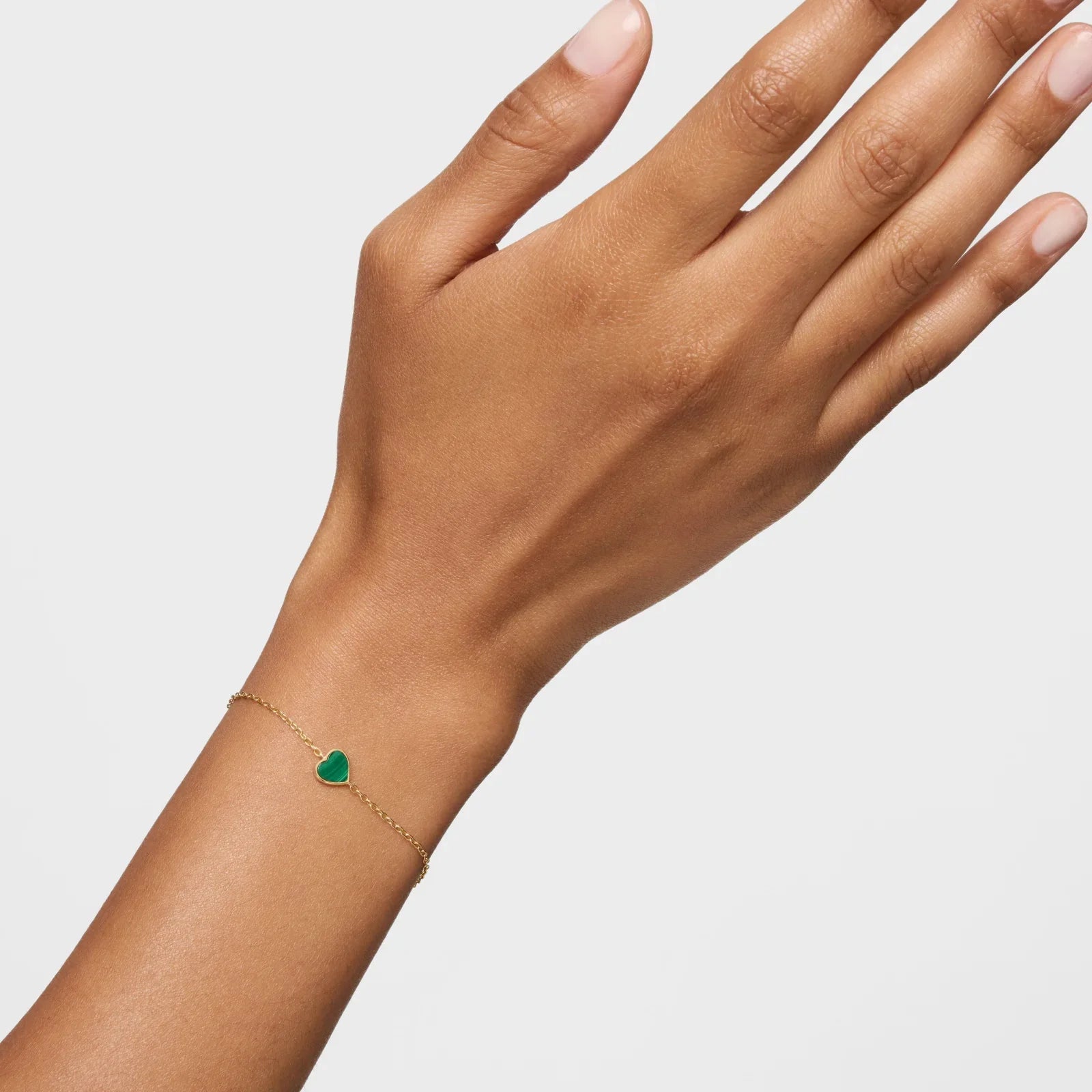 צמיד עדין מזהב עם תליון לב ירוק על יד, תכשיט יוקרתי מבית CHOZEN