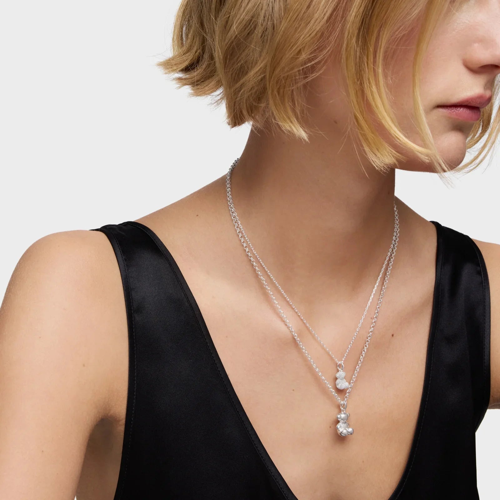 שרשרת כסף בעיצוב כפול עם תליון פנינה, על דוגמנית בחולצת סאטן שחורה, מבית CHOZEN