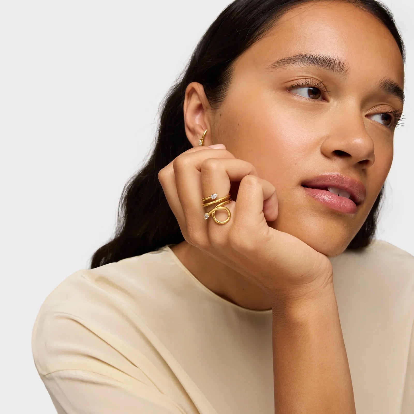 אישה עונדת תכשיטים זהב יוקרתיים, טבעות ועגיל, מבית CHOZEN מותגי על מבית קבוצת אלפא