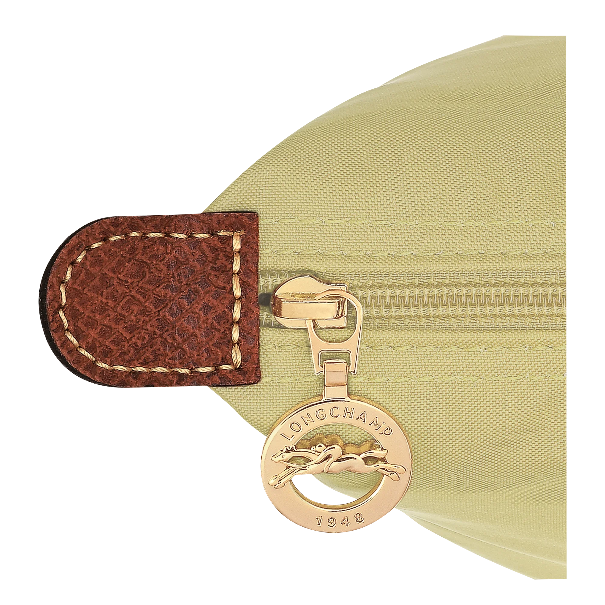 רוכסן תיק בצבע בז' של המותג Longchamp עם תג מתכת מוזהב, מוצג בחנות CHOZEN