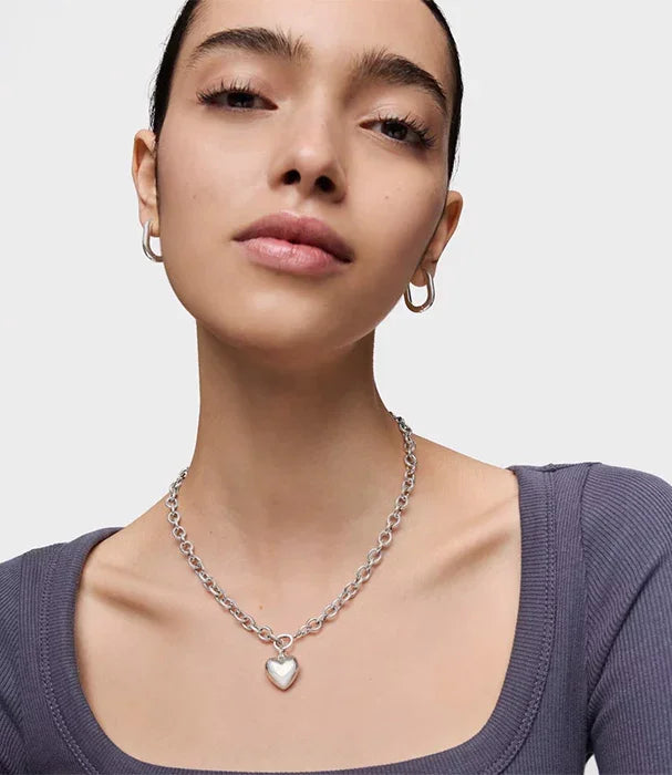 דוגמנית עונדת שרשרת כסף עם תליון לב ועגילי חישוק, צילום תכשיטים CHOZEN