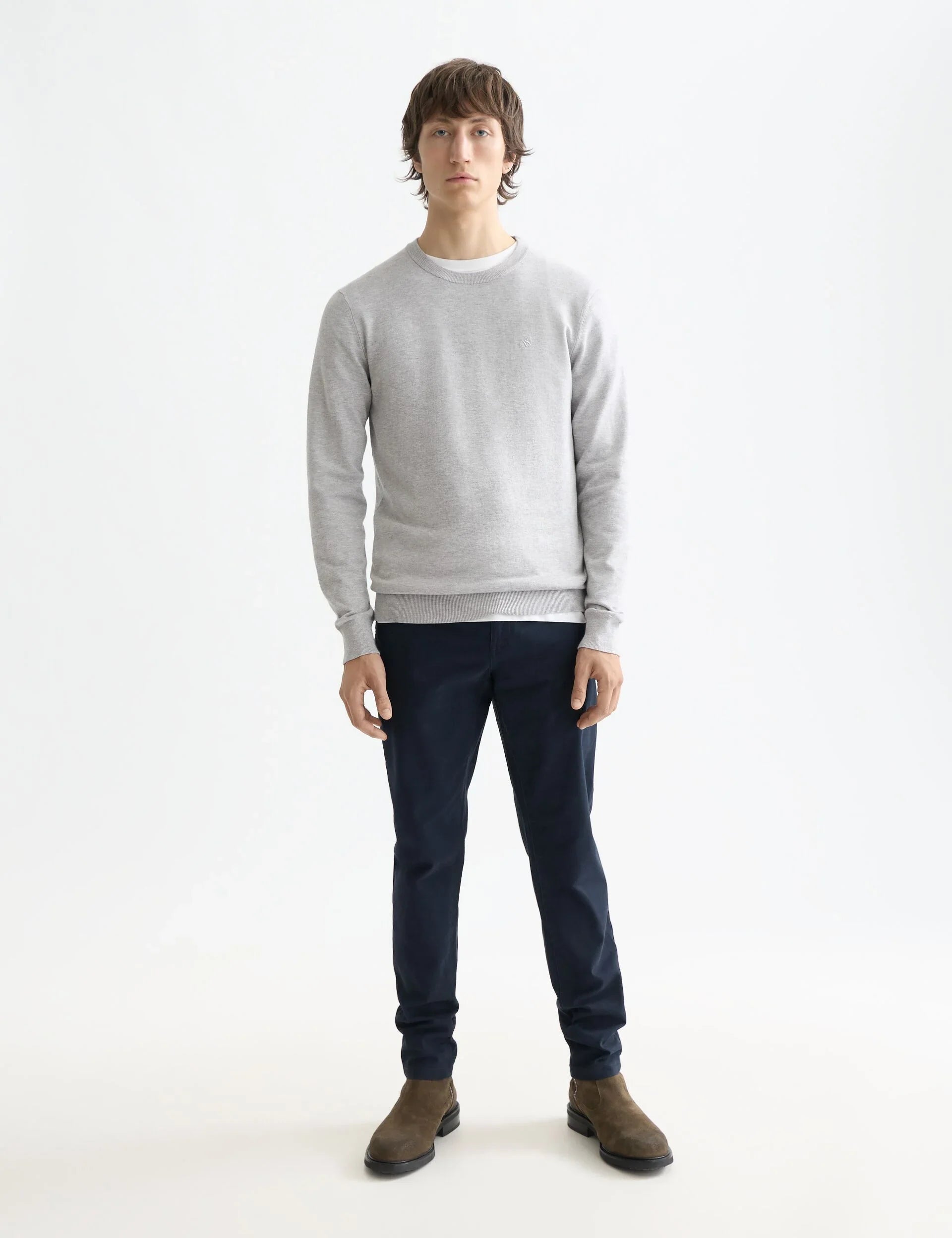 דוגמן לובש סווטשירט אפור ומכנסיים כהים, צילום אופנה לגבר באתר CHOZEN