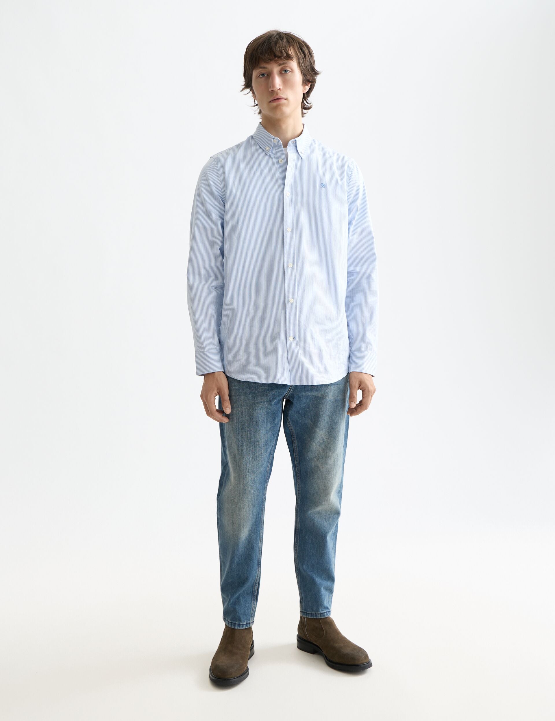 גבר לובש חולצת כפתורים תכלת ומכנסי ג'ינס, אופנה עדכנית מבית CHOZEN