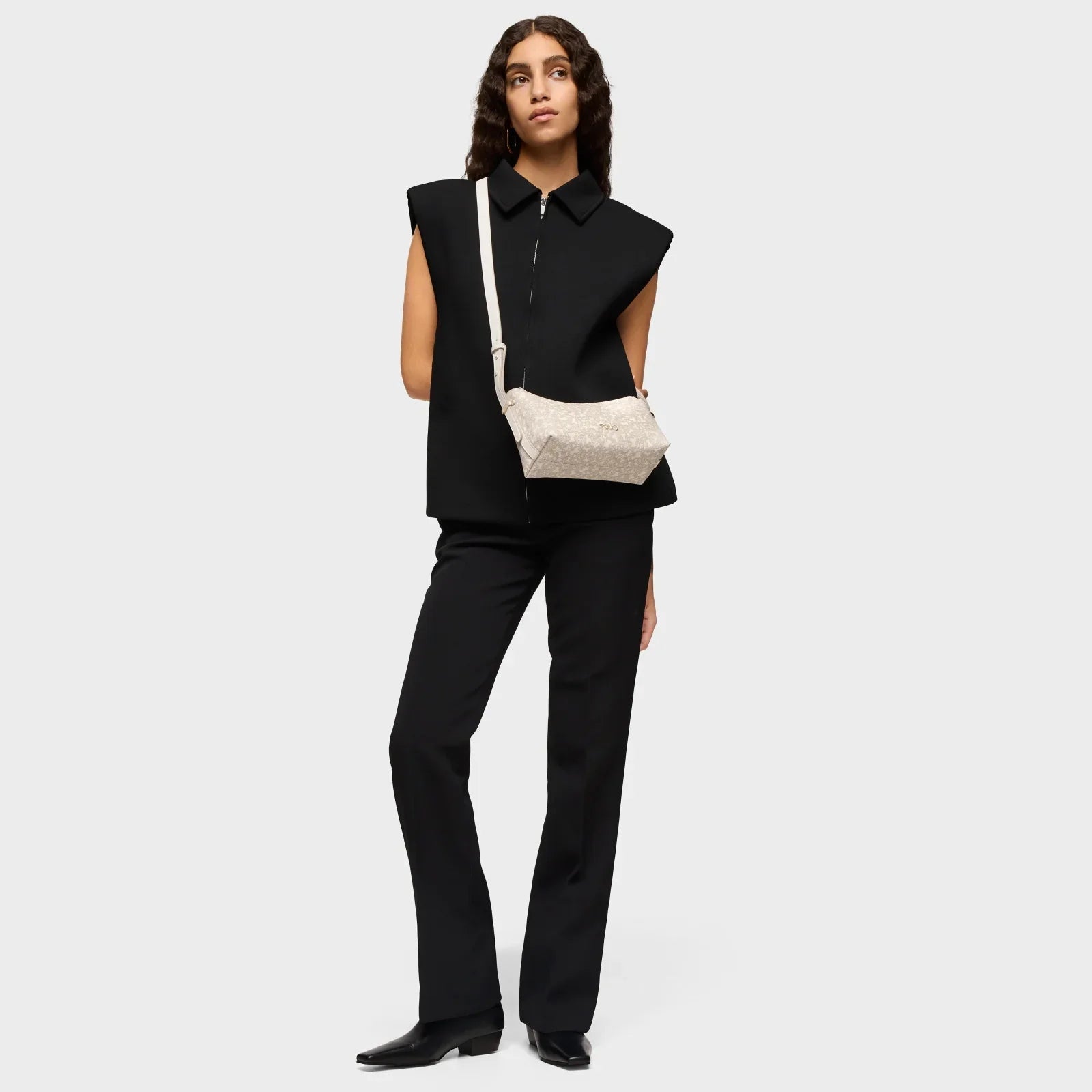 דוגמנית בלבוש שחור אלגנטי נושאת תיק צד אופנתי, קולקציית המותגים CHOZEN