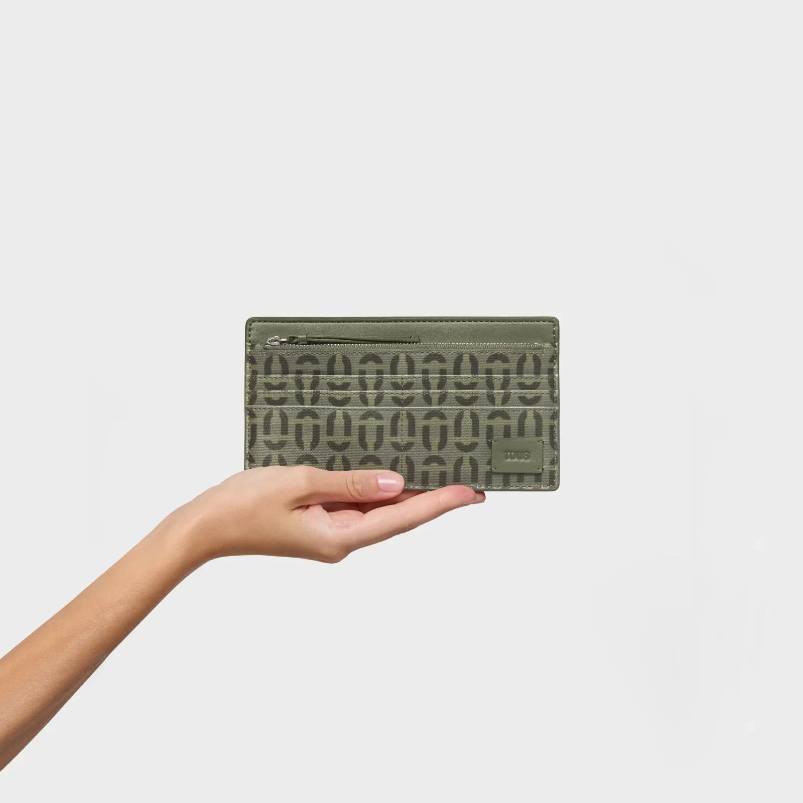 ארנק מעוצב ירוק של TOUS על רקע לבן, מוצר מוביל באתר CHOZEN מבית קבוצת אלפא