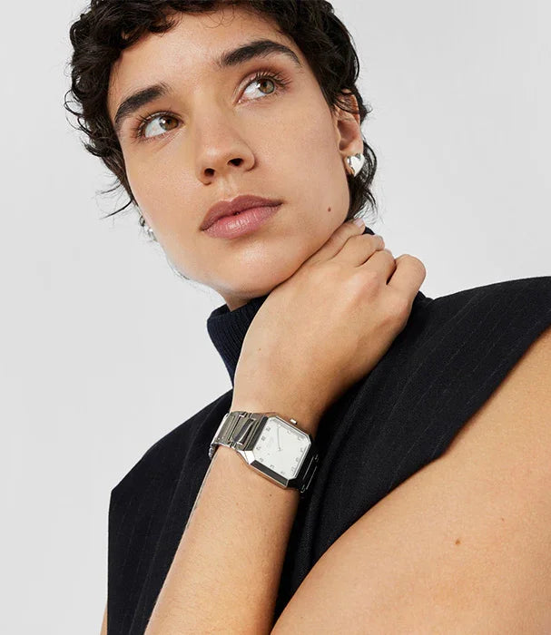 אישה עם שיער קצר עונדת שעון יד כסף אופנתי, CHOZEN מותגים מובילים, קבוצה אלפא