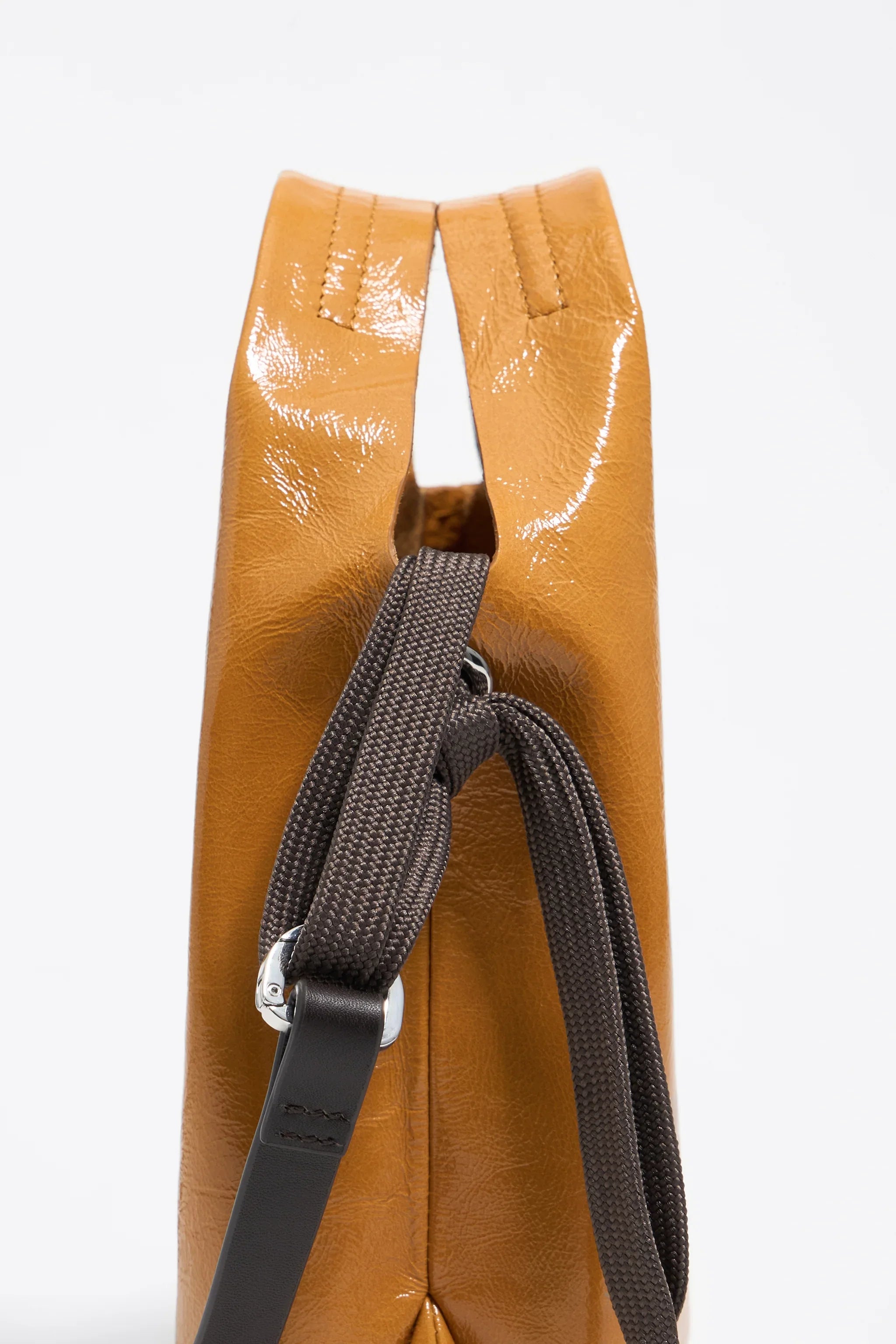 תיק עור חום מבית CHOZEN עם רצועה שחורה, צילום צד, מראה יוקרתי ועדכני