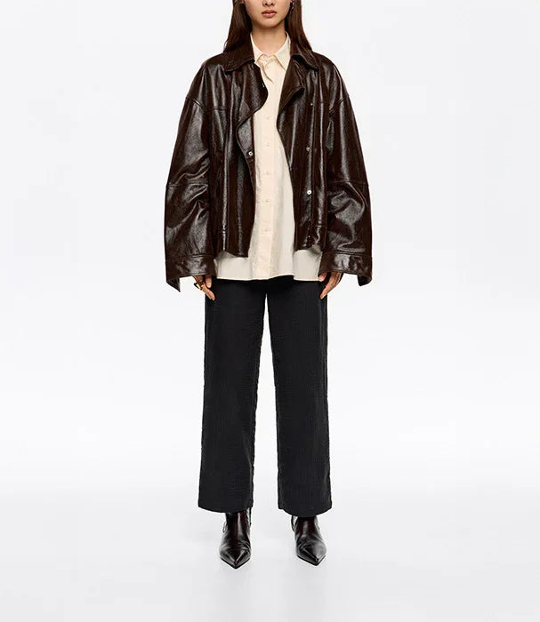 אופנת נשים CHOZEN, דוגמנית עם ז'קט עור חום, חולצה בהירה ומכנסיים שחורים מהמבחר המוביל