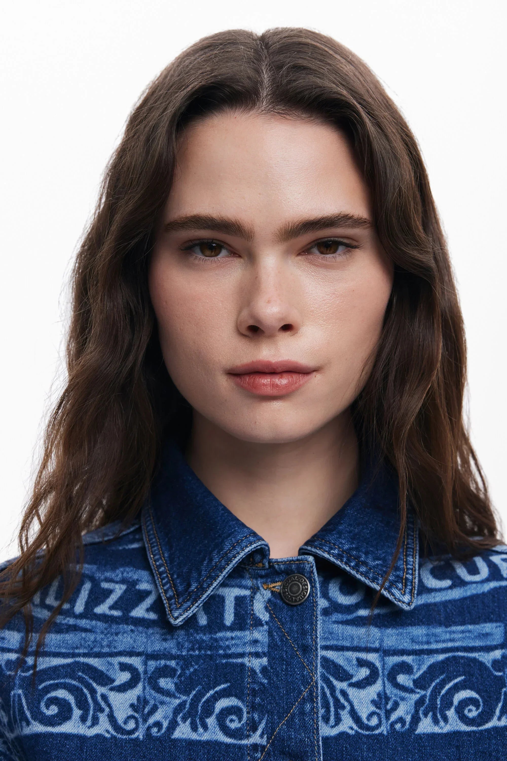 אישה עם שיער חום ארוך לובשת ז'קט ג'ינס מעוצב, אופנה עדכנית CHOZEN מבית קבוצת אלפא