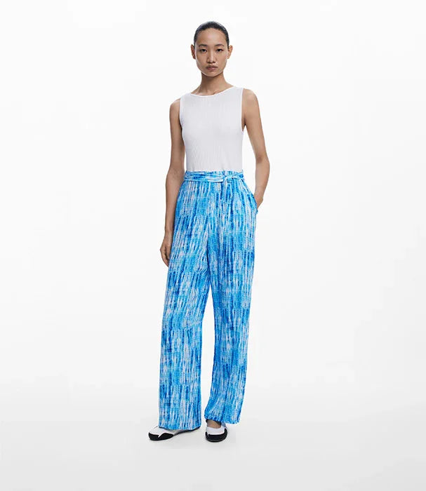 דוגמנית לובשת גופיה לבנה ומכנסיים רחבים מודפסים בכחול, אופנת נשים CHOZEN