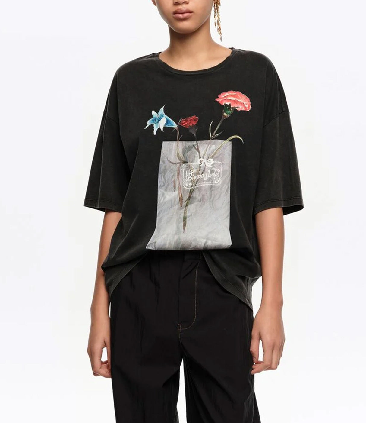 חולצת טי שחורה עם הדפס פרחים צבעוניים בקדמת החולצה, מראה אופנתי מודרני