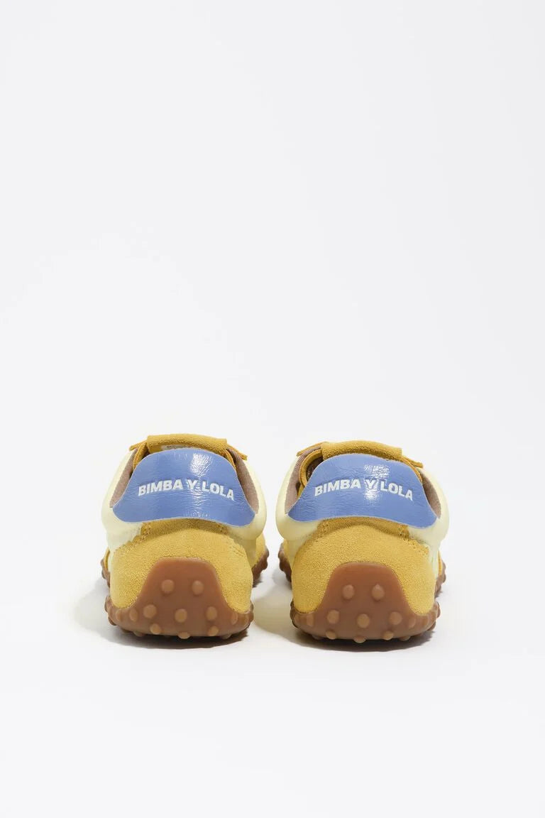 נעלי ספורט נשים בצבע צהוב וחום, סוליה חומה, דיטייל כחול עם כיתוב בחלק האחורי