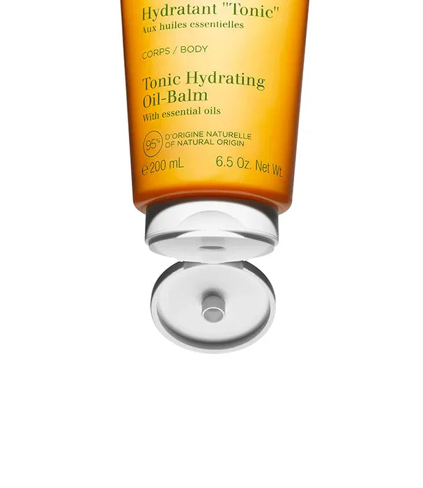 קרם גוף לחות שמן טוניק Clarins, שפופרת כתומה פתוחה, מוצר טיפוח יבש בהצעת CHOZEN