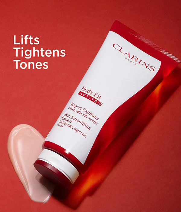 קרם גוף קלרינס Body Fit Active על רקע אדום, מוצר טיפוח להחלקת עור מבית מותג מוביל