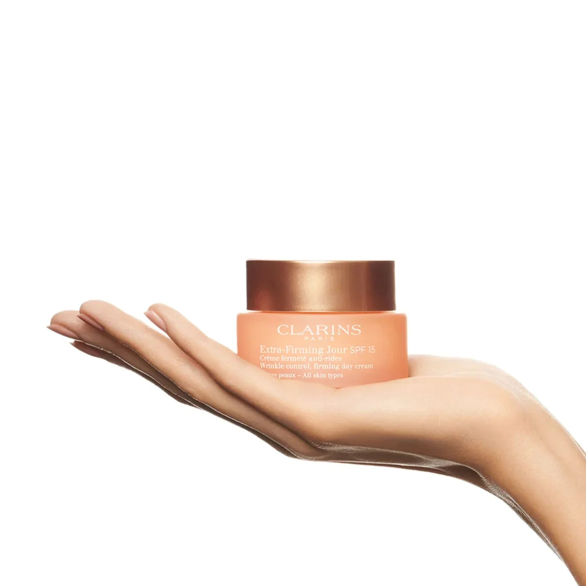 קרם יום קלרינס Extra-Firming SPF 15 מוצג על כף יד, מוצר טיפוח של מותג עולמי CHOZEN