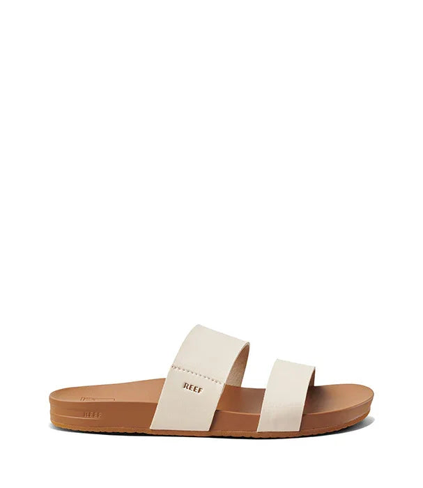 סנדל נשים שטוח עם שני רצועות בצבע בז' על רקע לבן, מתאים לקיץ ואופנה יומיומית