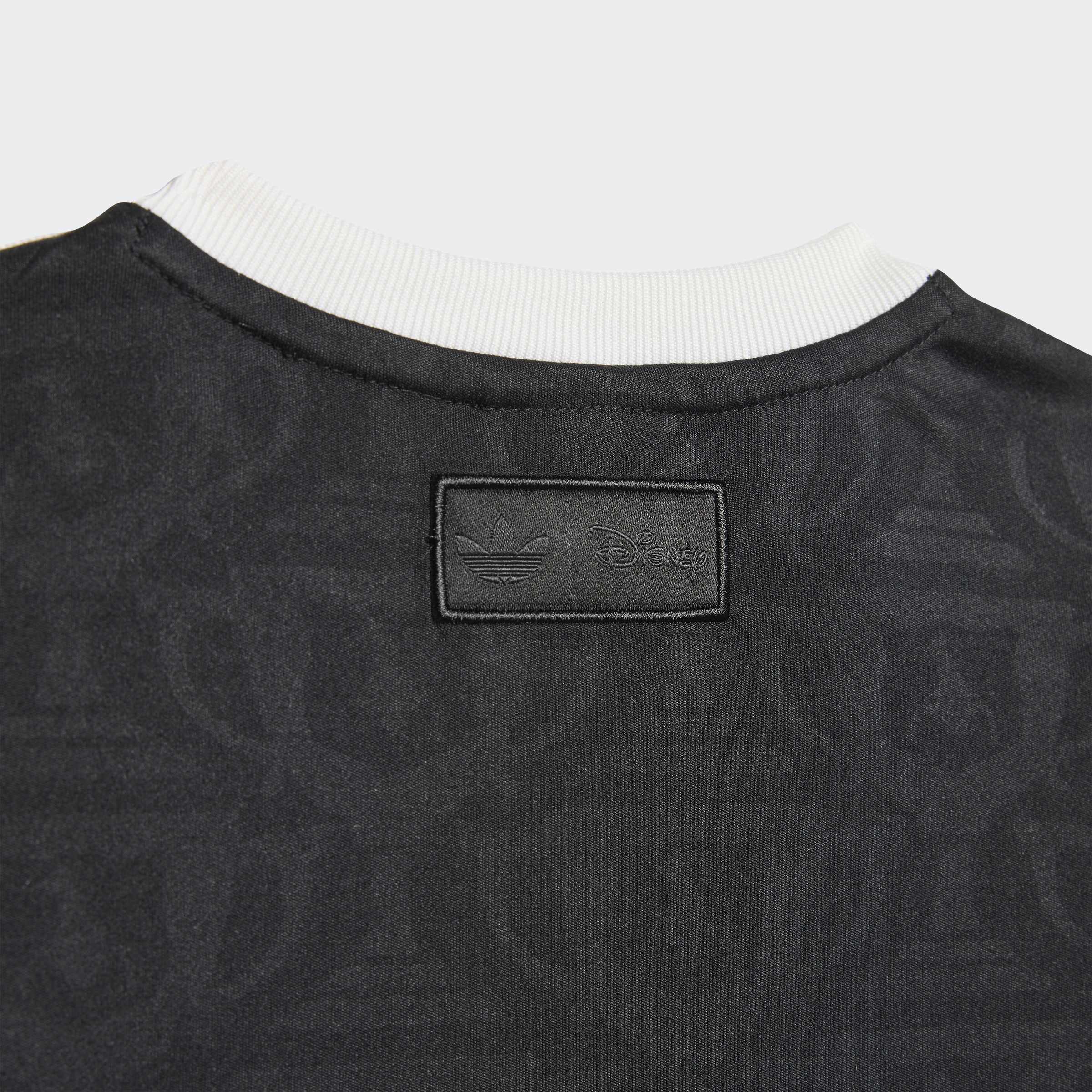 חולצה אפורה עם תג עור שחור בגב הצווארון, גימור לבן בצוואר