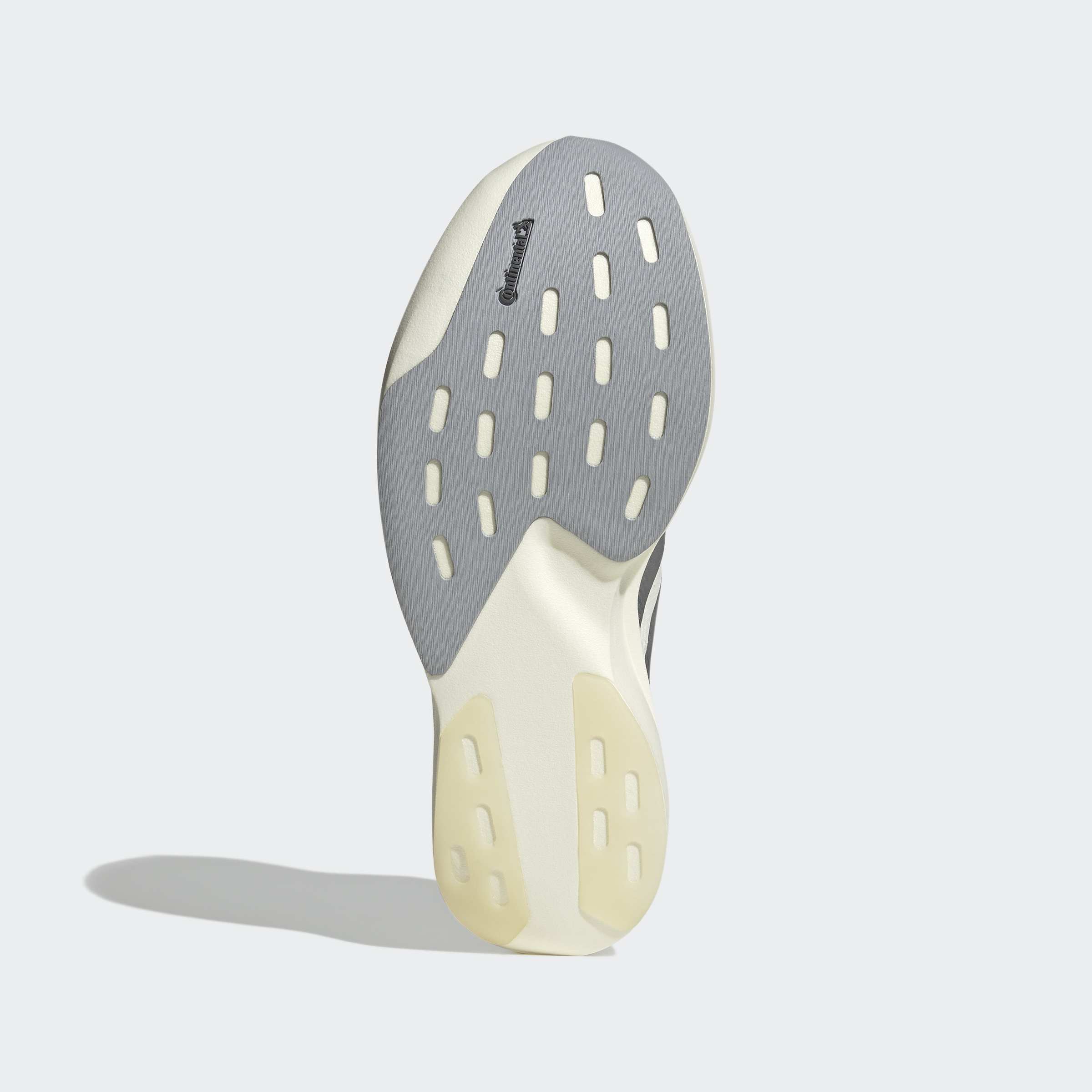 סוליית נעל ספורט בצבע אפור ולבן, תבליט אחיזה ובולמי זעזועים