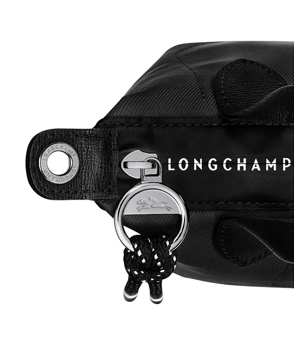 תקריב של תיק LONGCHAMP שחור עם רוכסן תליון מטאלי לוגו, עיצוב יוקרתי, CHOZEN מותגים מובילים