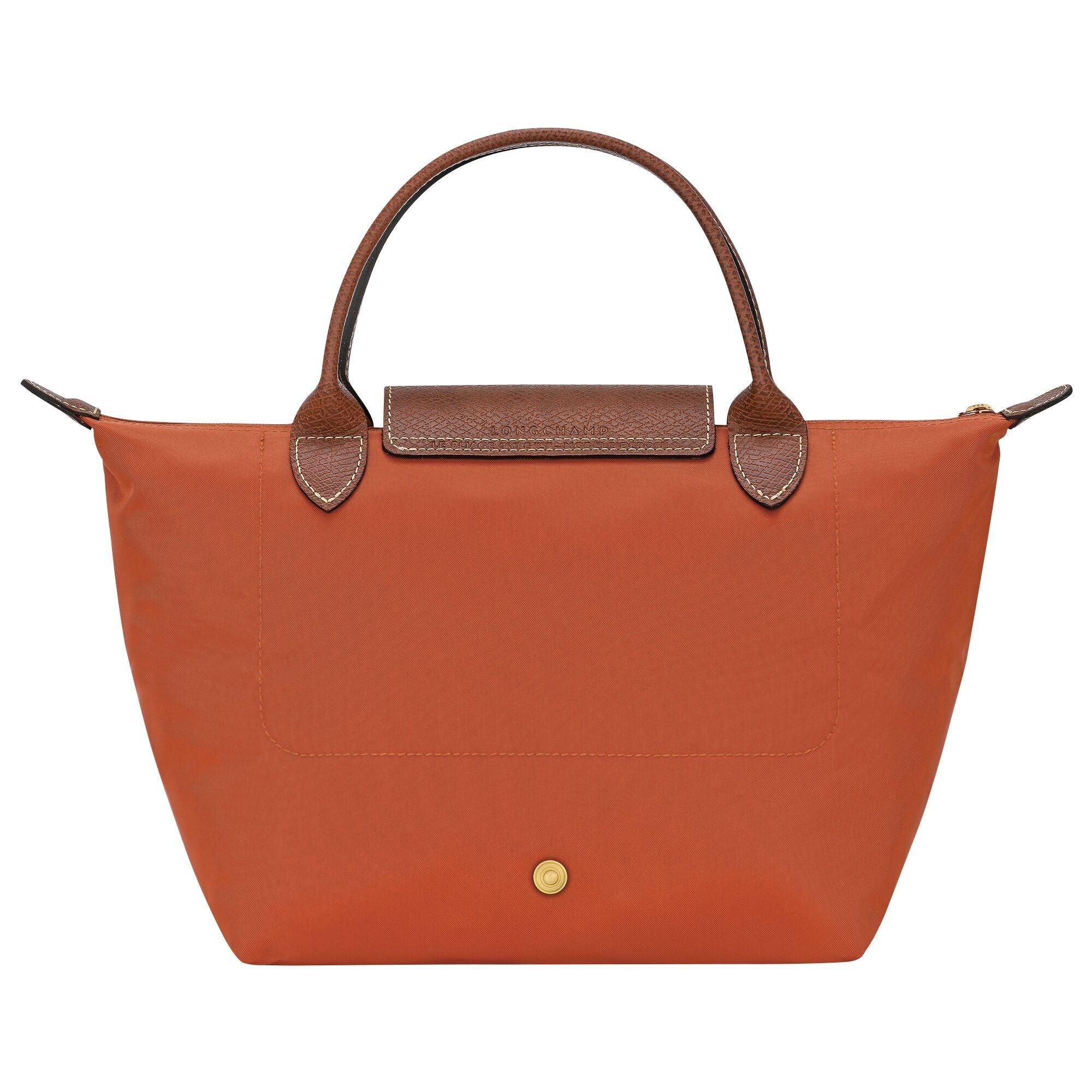 תיק יד כתום עם ידיות וחלק עליון מעור חום, מבית מותג יוקרה ב-CHOZEN