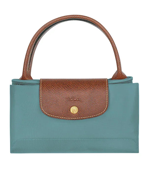 תיק יד לנשים מבית CHOZEN, גוף טורקיז וידיות וסוגר עור חום, עיצוב יוקרתי אלגנטי