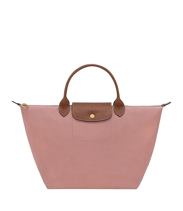 תיק יד ורוד עם ידיות ועיטורים חומים, מותג אופנה בינלאומי בחנות CHOZEN