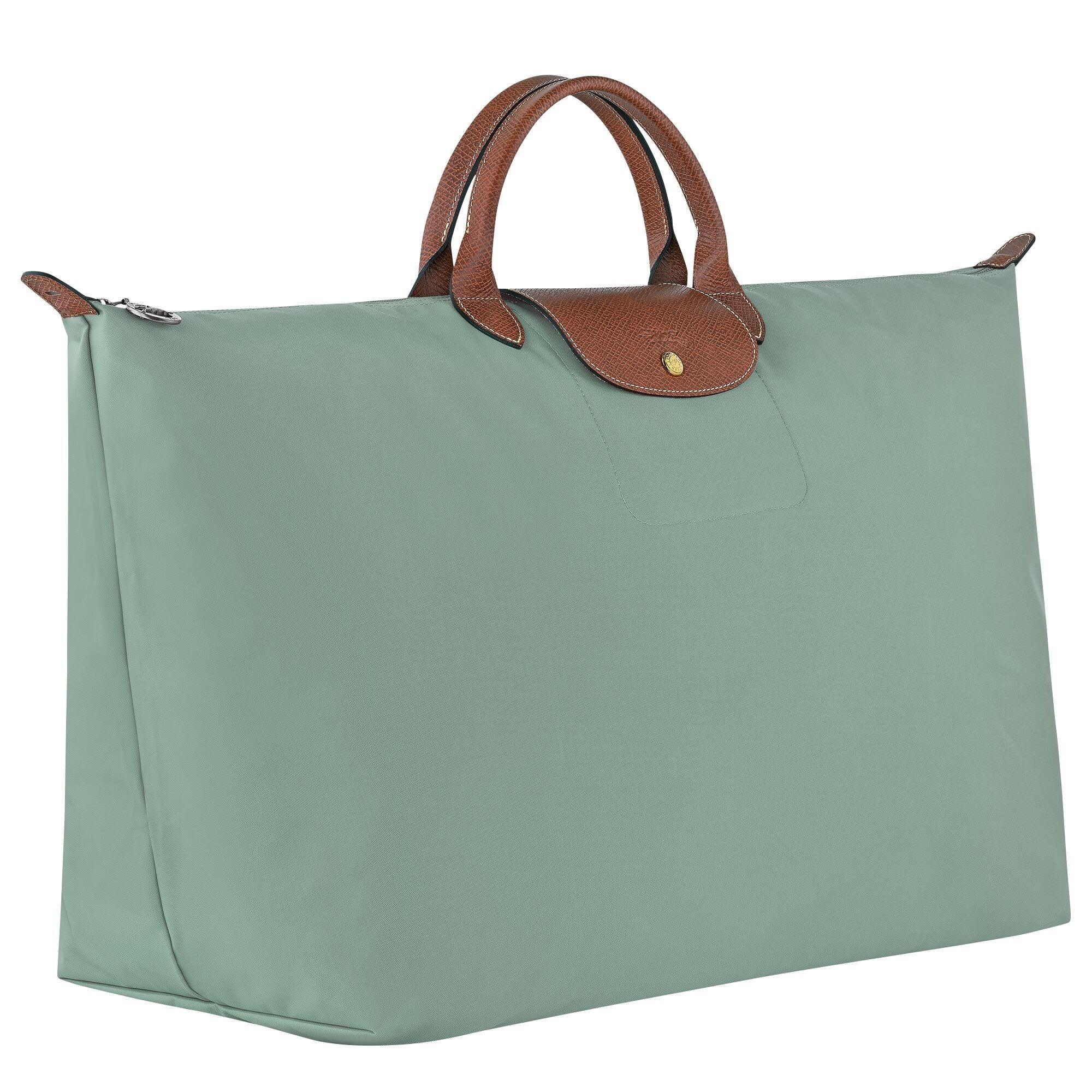 תיק נשיאה ירוק עם ידיות עור חום, עיצוב יוקרתי, מוצג ב-CHOZEN מבית קבוצת אלפא