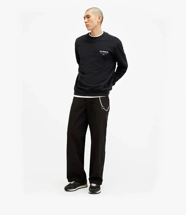 דוגמן לובש סווטשירט שחור ומכנסיים רחבים, אופנה אורבנית ממותגי CHOZEN