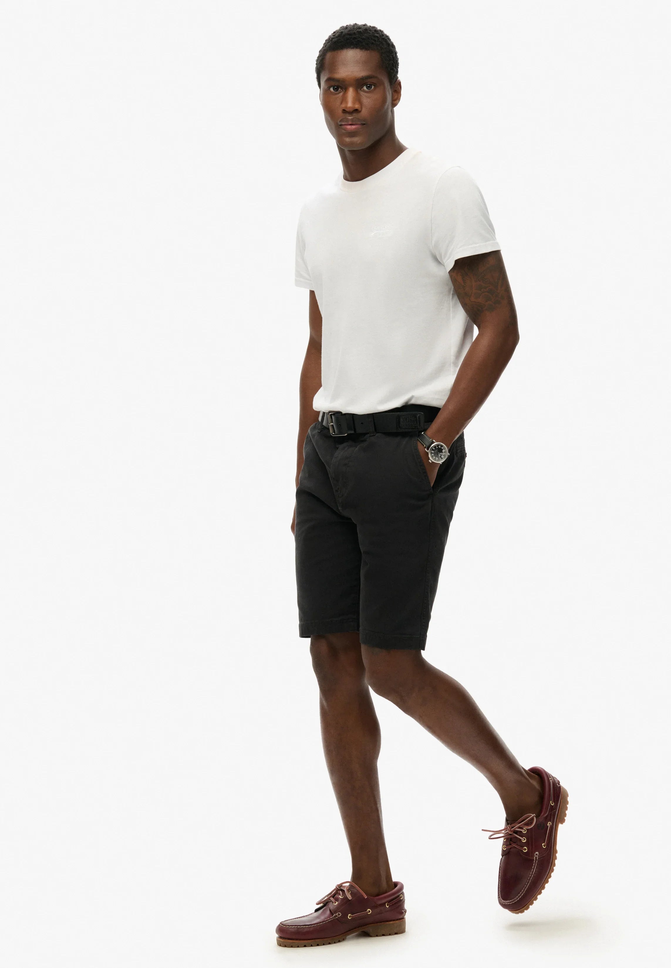 גבר לבוש בחולצה לבנה, מכנסיים קצרים שחורים ונעלי מוקסין חום, אופנת קיץ CHOZEN