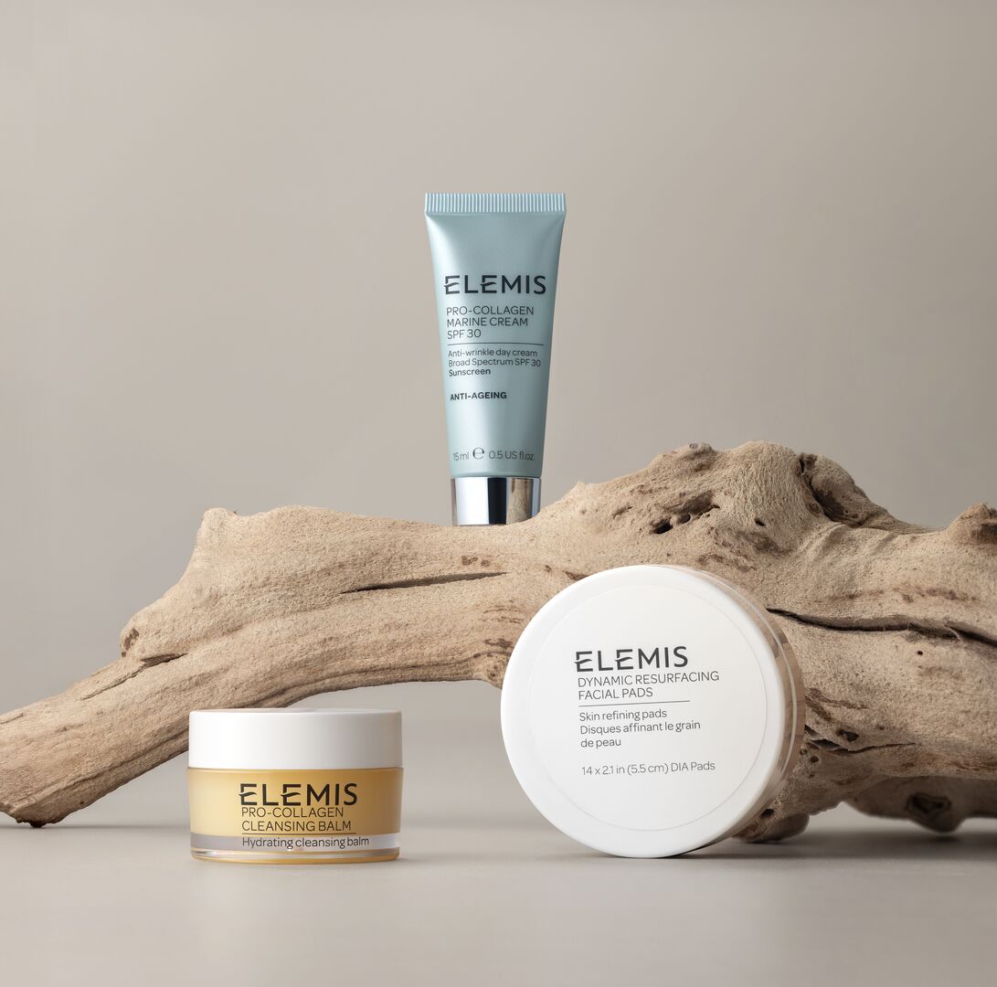 סט מוצרי טיפוח פנים של Elemis על גזע עץ, כולל קרם לחות, פדים ומרכך