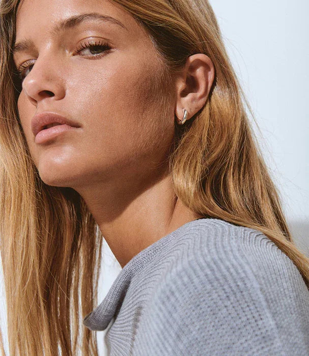 אישה עם שיער בלונדיני עונד עגיל כסף, אופנה עדכנית מבית CHOZEN