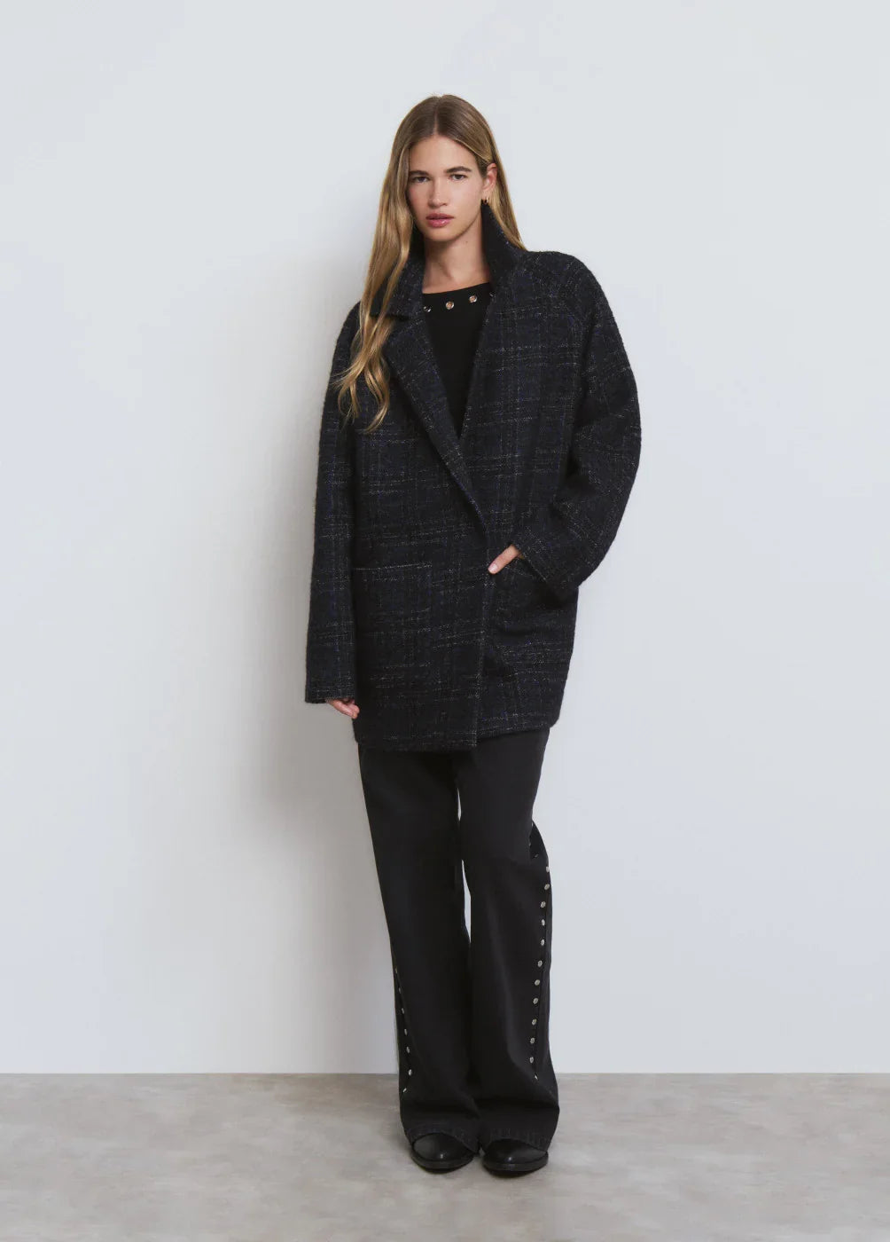 מעיל נשים שחור עם טקסטורת משבצות אלגנטית, על רקע לבן נקי, מבית CHOZEN מותגי יוקרה