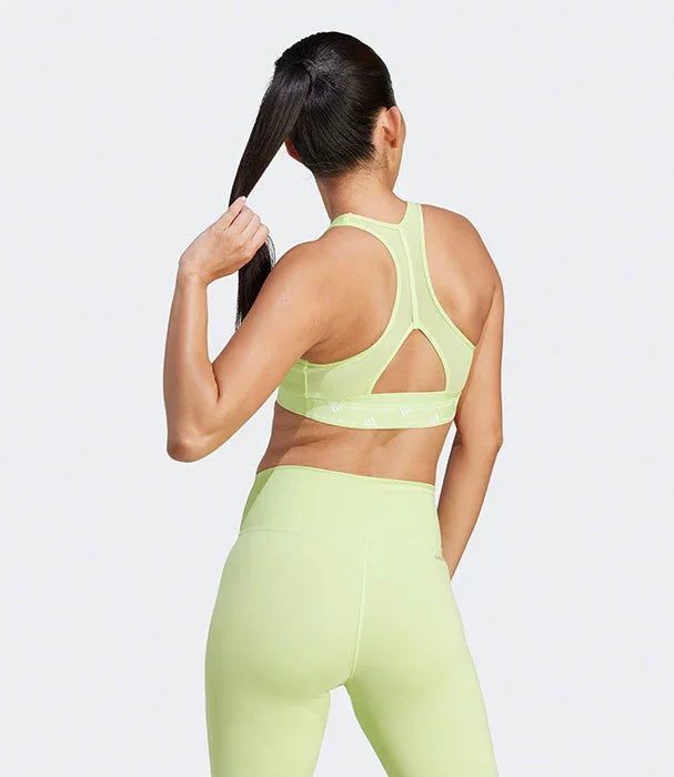 אישה בלבוש ספורטיבי ירוק בהיר, מצולמת מאחור, דגם אופנה באתר CHOZEN