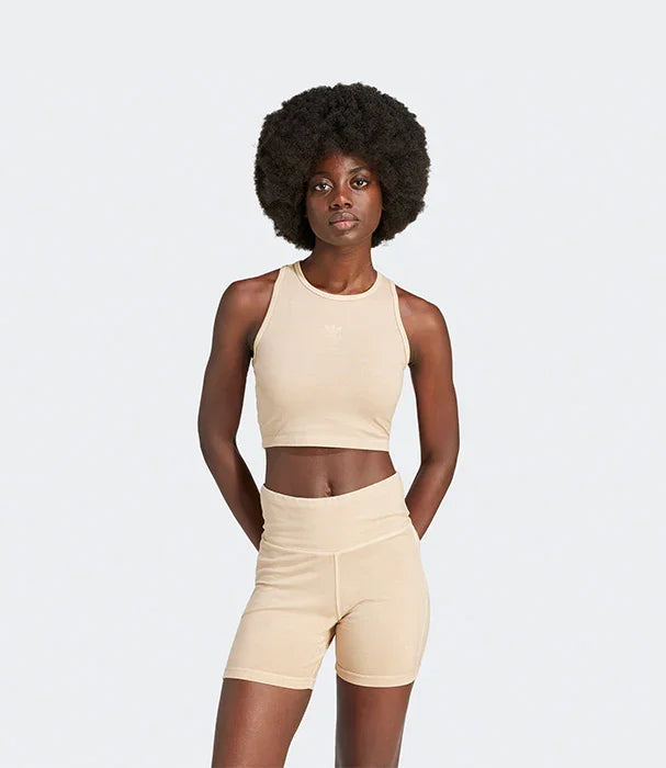 דוגמנית לובשת סט בגדי ספורט בגוון בז' של Adidas, קולקציית CHOZEN, רקע אפור