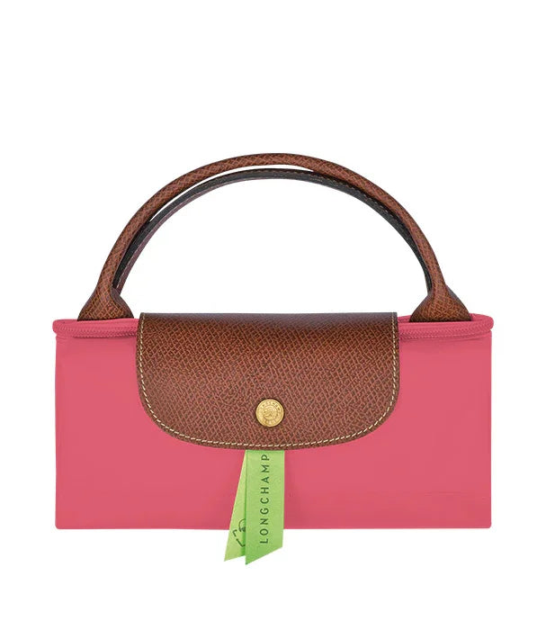 תיק יד ורוד עם ידיות וכיסוי עור חום מבית Longchamp, מוצג על רקע לבן באתר CHOZEN