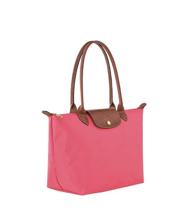 תיק יד אופנתי לנשים בצבע ורוד עם ידיות חומות, מוצג ב-CHOZEN, אופנה יוקרתית