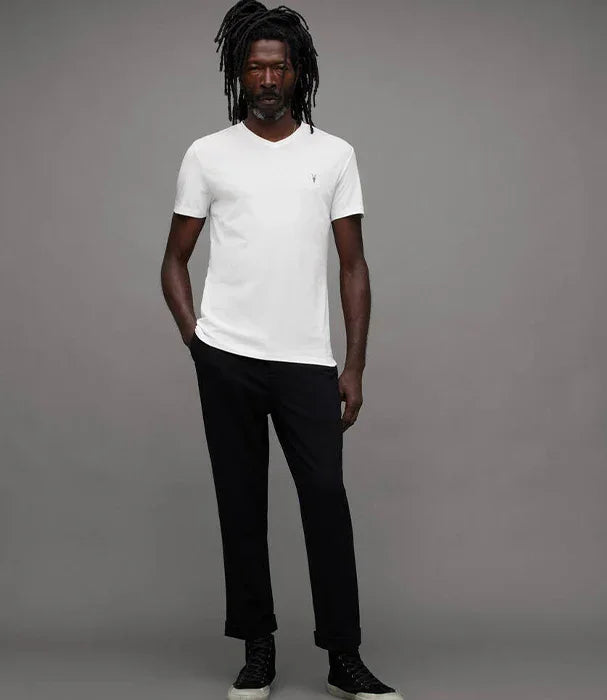 דוגמן עומד בחולצה לבנה ומכנסיים שחורים, מותגים מובילים CHOZEN, רקע אפור