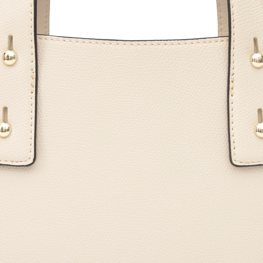 תקריב של תיק יד מעור בצבע בז', מרקם עור ותפרים בולטים, פרטי מתכת זהובים