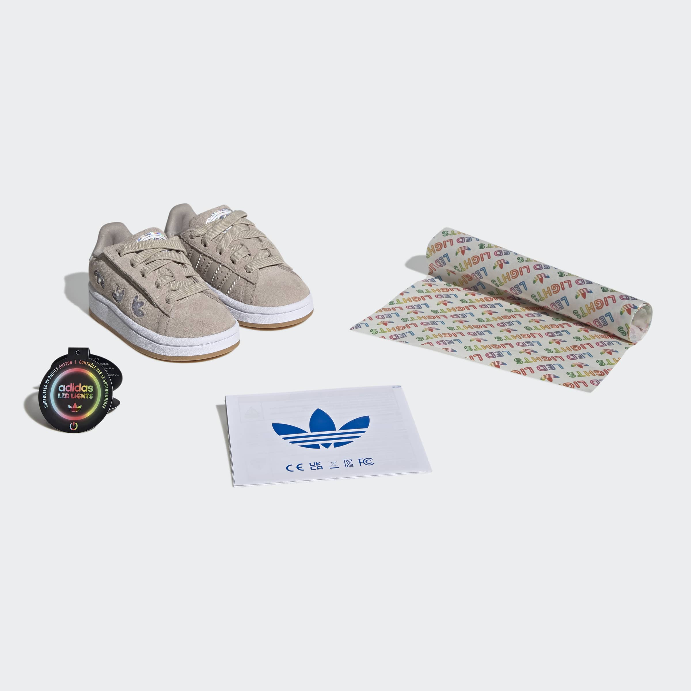 נעלי סניקרס ילדים בגוון אפור בהיר, שרוכים, סוליה לבנה, כולל גאדג'ט תאורה, נייר עטיפה ודף הוראות